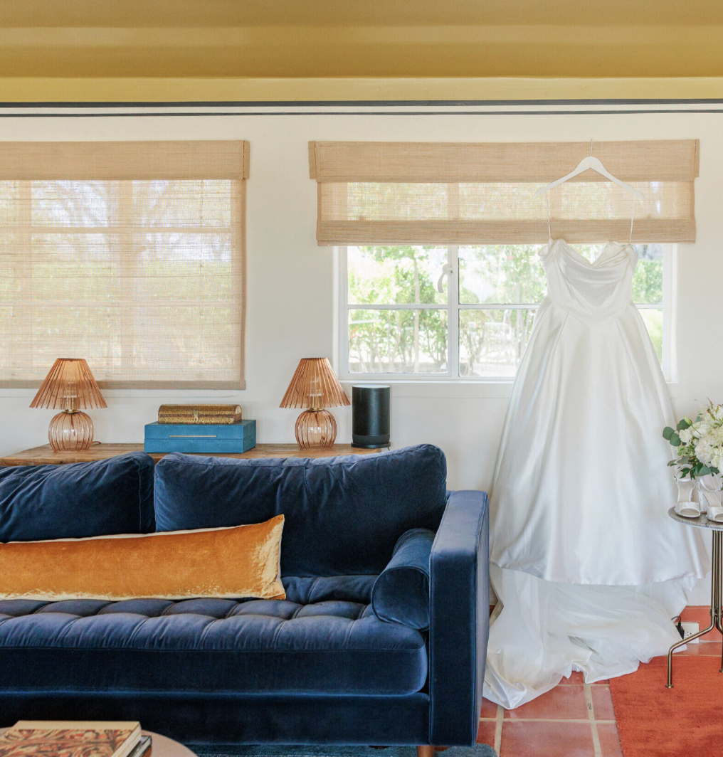 Wedding dress hanging inside the Wedding Cottage beside the lounge seating