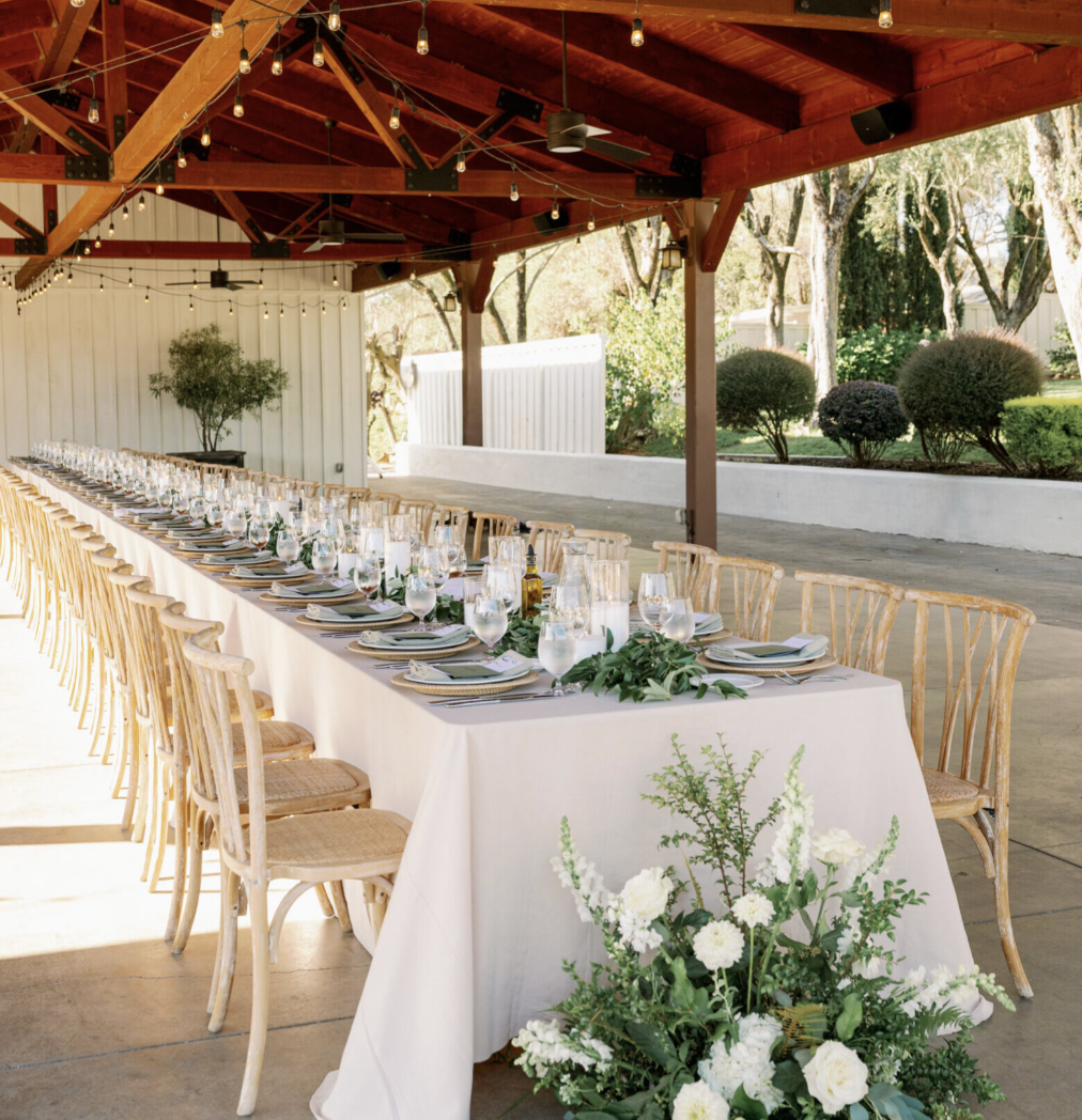 Long table reception layout inside the Vineyard Pavilion