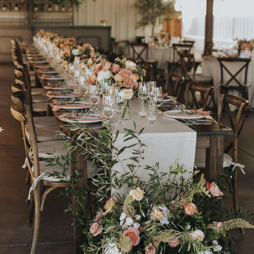 Vineyard Pavilion dining setup with floral arrangements